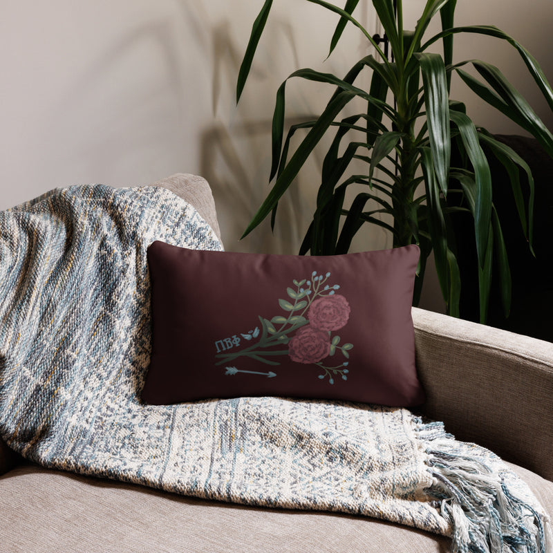 Pi Beta Phi wine carnation design pillow in 20" x 12" lumbar pillow size shown on couch