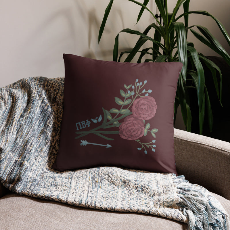 Pi Beta Phi wine carnation design pillow in 22" x 22" lumbar pillow size shown on couch