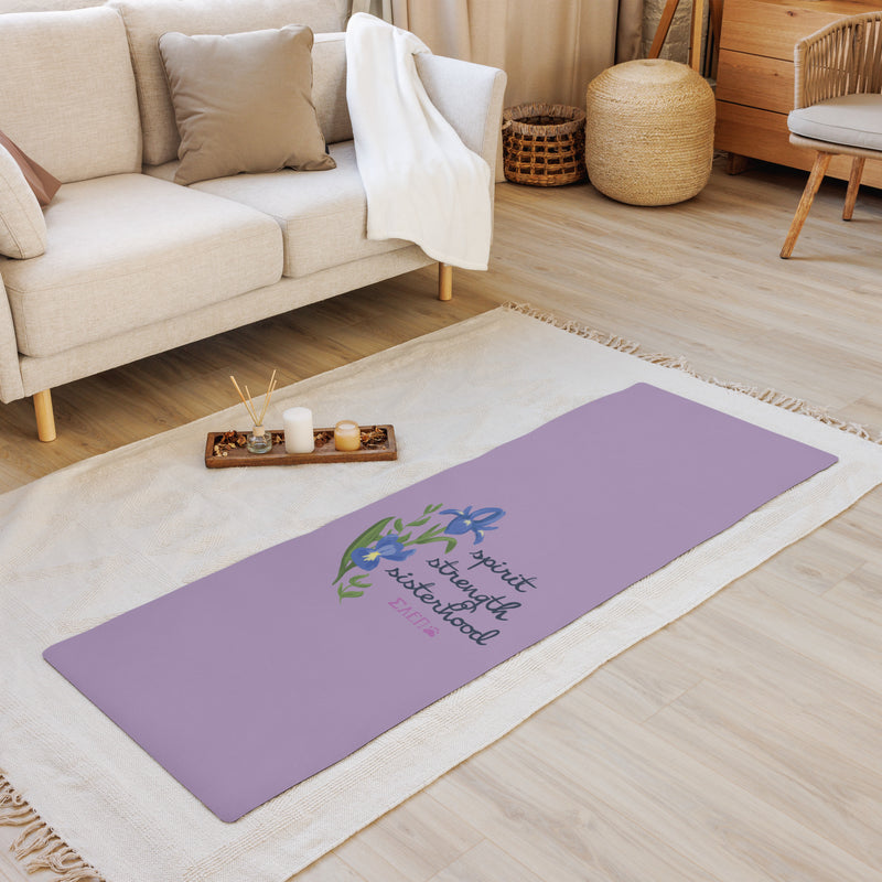 SAEPi motto yoga mat shown on floor with candles