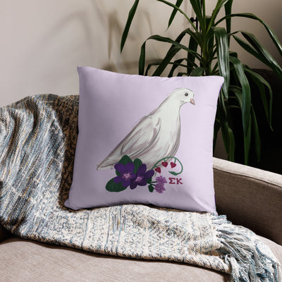 Sigma Kappa Dove Mascot Reversible Pillow showing dove design on front of 22" x 22" size pillow shown on couch