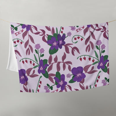 Sigma Kappa Floral Print Throw Blanket in lavender with violet shown hanging on clothesline