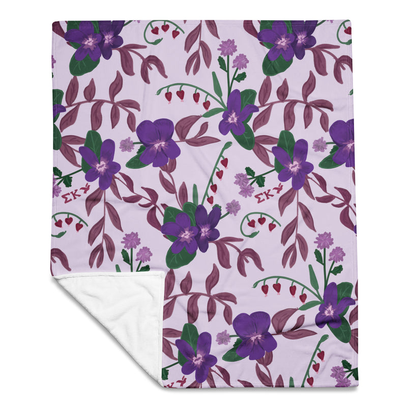 Sigma Kappa Floral Print Throw Blanket in lavender showing solid white reverse side