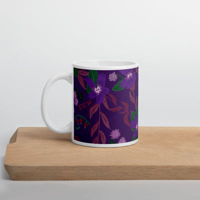 Sigma Kappa violet floral print mug shown in violet on wooden cutting board in 11 oz size