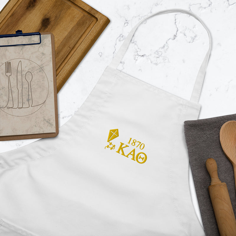 white embroidered theta apron