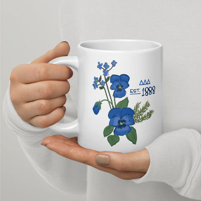 Tri Delta 1888 mug in 20 oz size shown in model's hands with handle on left