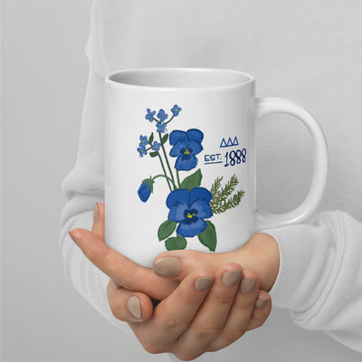 Tri Delta 1888 mug in white shown in 20 oz size in model's hands with handle on right