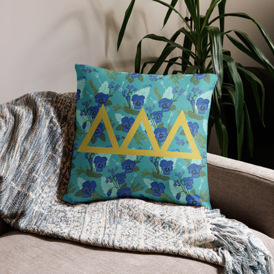 Tri Delta Letters Pillow shown in 22" x 22" size with signature floral print on couch