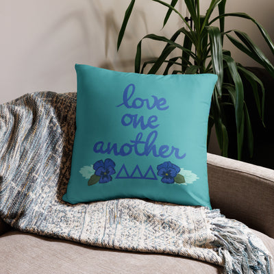 Tri Delta Sorority Pillow showing Love One Another design in 22" x 22" size on couch