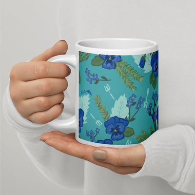 Tri Delta floral print sorority mug in 20 oz size in teal shown in model's hands