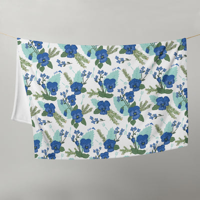 Tri Delta Pansy Floral Print Throw Blanket hanging on clothesline