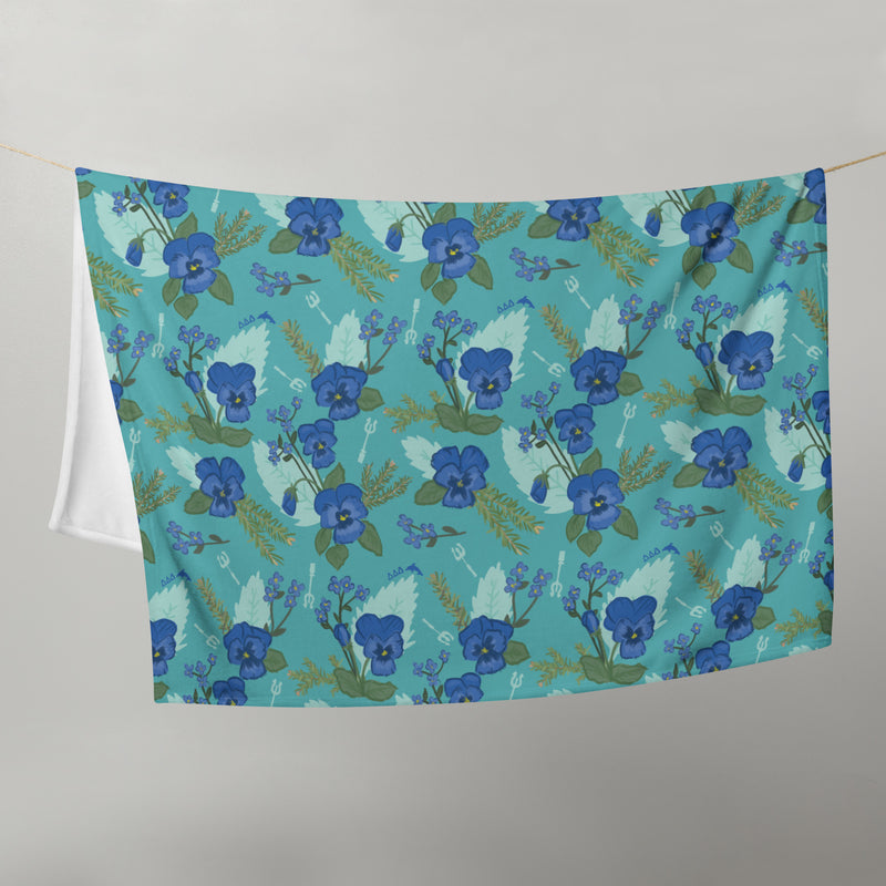 Tri Delta Pansy Floral Print Teal Throw Blanket shown on clothesline