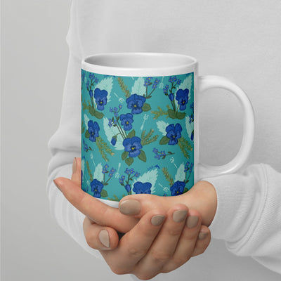 Tri Delta Sorority Mug with pansy floral print in teal shown on 20 oz mug