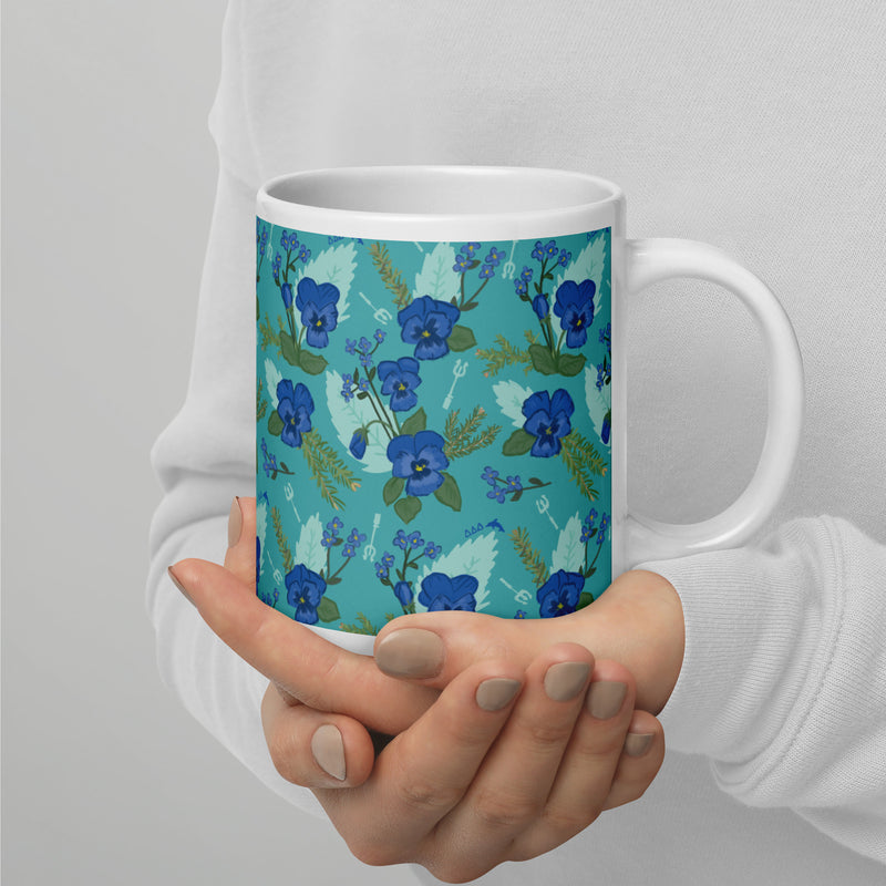 Tri Delta Sorority Mug with pansy floral print in teal shown on 20 oz mug