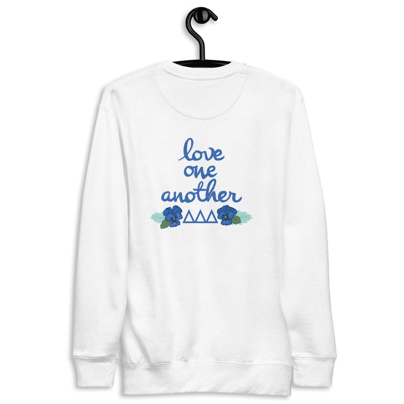 Tri Delta Love One Another White Crew Neck Sweatshirt shown on hanger