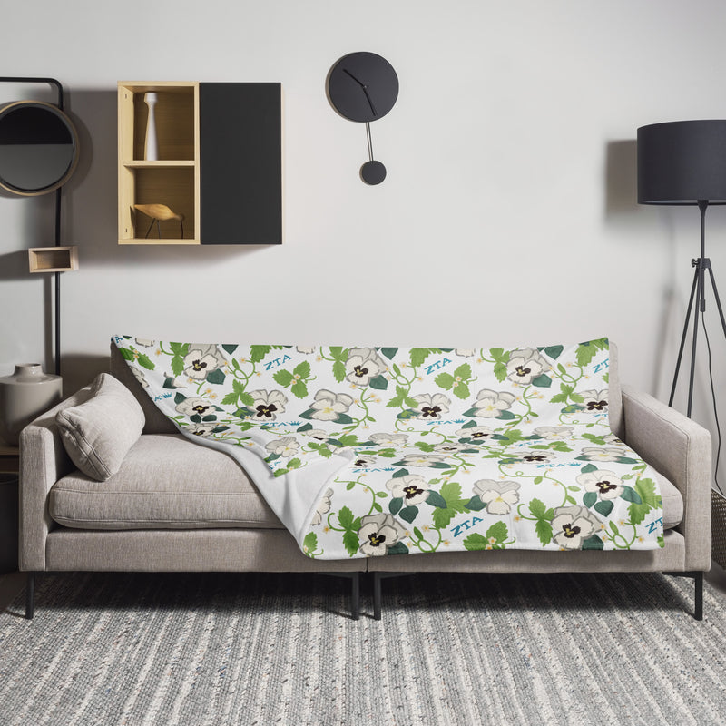 Zeta Tau Alpha Violet Print Blanket in white 60" x 80" size shown on couch