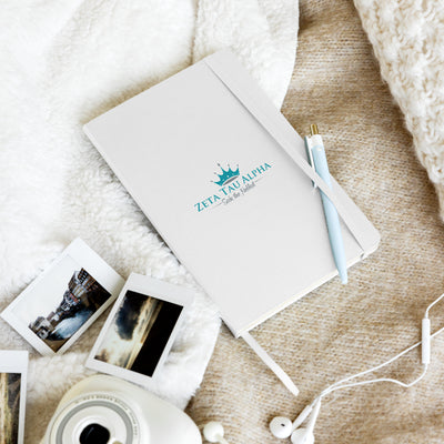 Zeta Tau Alpha Logo and Motto Journal in white shown in lifestyle setting