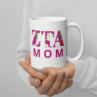 Zeta Tau Alpha Mothers Day 15 oz Mug shown in model's hands with handle on right