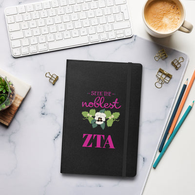 Zeta Seek the Noblest Motto Journal in black shown in lifestyle setting