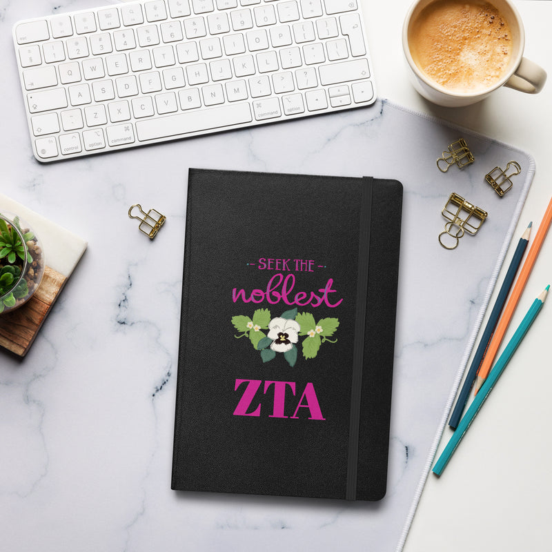 Zeta Seek the Noblest Motto Journal in black shown in lifestyle setting