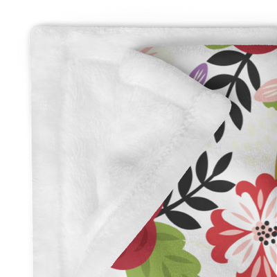 Alpha Chi Modern Floral throw blanket in white shown folded and showing white backing
