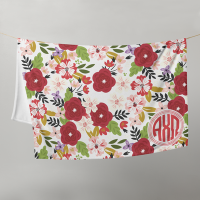 Alpha Chi Modern Floral throw blanket hanging on a clothes line in white.