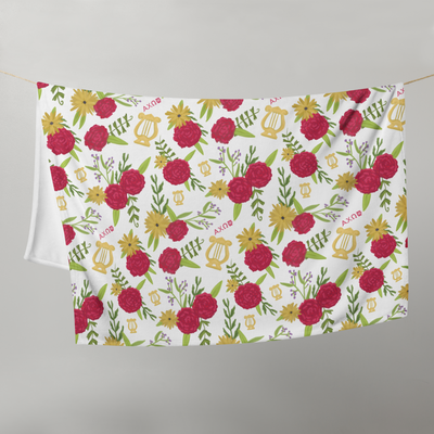Alpha Chi Omega Carnation Floral Print Throw Blanket, White shown on clothesline