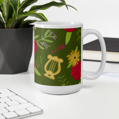 Alpha Chi Omega Floral Print Mug, Olive Green shown in 15 oz size with handle on right in office