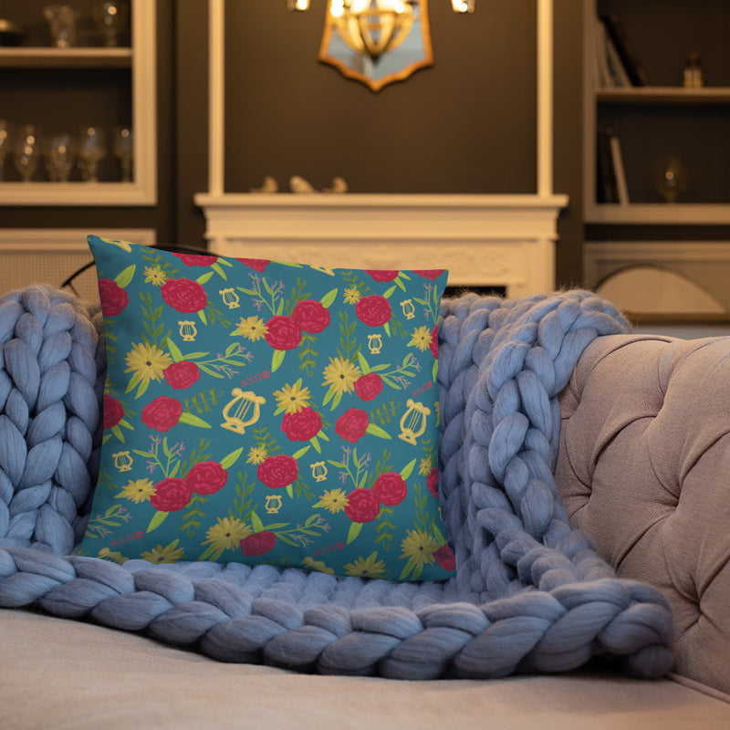 Alpha Chi Omega Together Let Us Seek the Heights Teal Pillow showing back with floral print on couch
