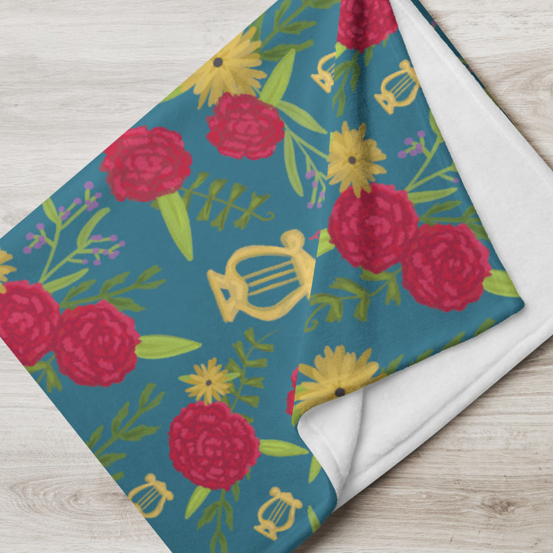 soft and warm Alpha Chi Omega throw blanket with a red carnation floral print with a teal background