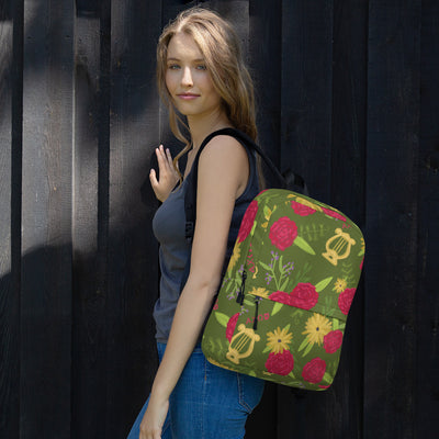 Alpha Chi Omega green floral backpack shown on woman's back