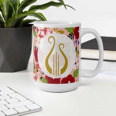 Alpha Chi Omega Modern Floral Print Hera Pink Mug with Lyre in 15 oz size shown in office