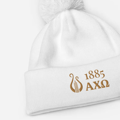 Alpha Chi Omega 1885 Lyre Pom Pom Beanie shown close up in white with old embroidery
