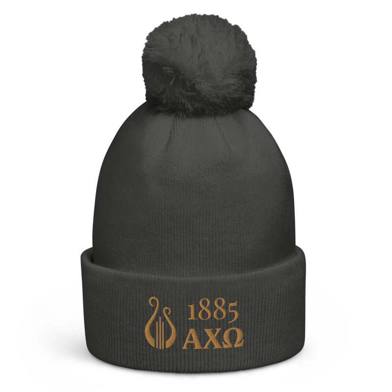 Alpha Chi Omega 1885 Lyre Pom Pom Beanie shown in close up view in gray