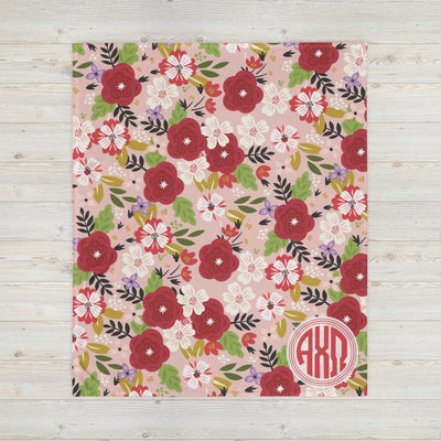 Our Alpha Chi Omega floral print throw blanket in Hera Pink shown in full sized view. 