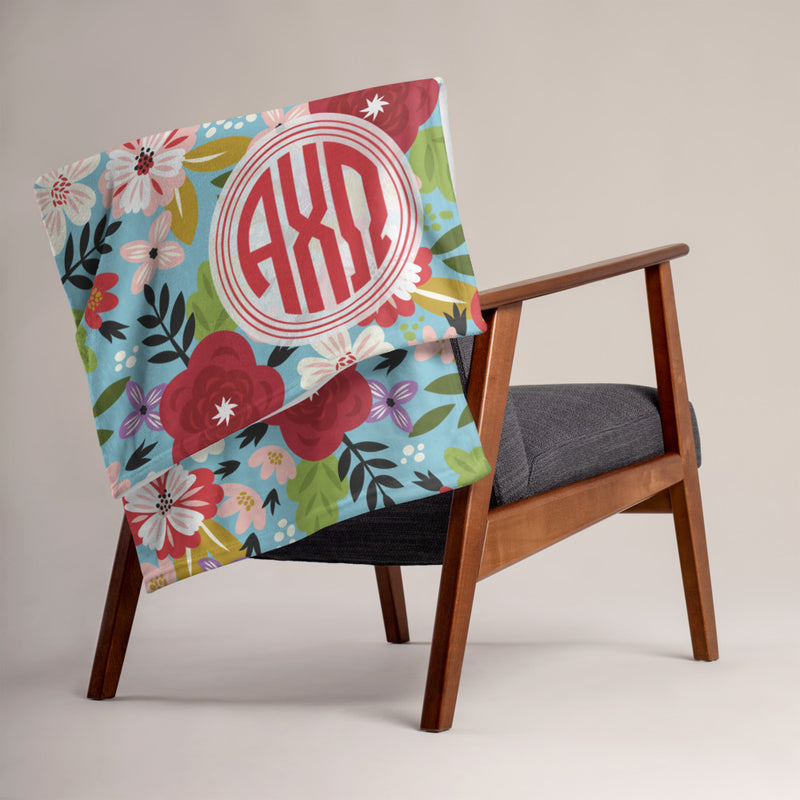 Alpha Chi Omega Modern Flora Olympus Throw Blanket shown over chair