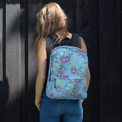 Alpha Delta Pi Floral print backpack featuring violets and diamonds shown on young woman's back in blue