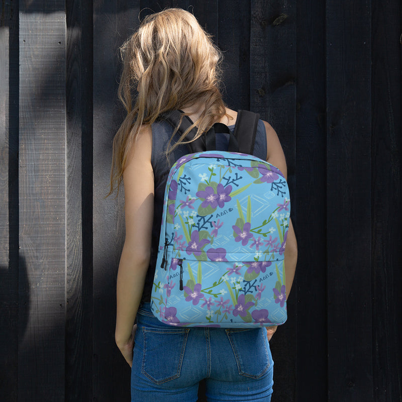 Alpha Delta Pi Floral print backpack featuring violets and diamonds shown on young woman&