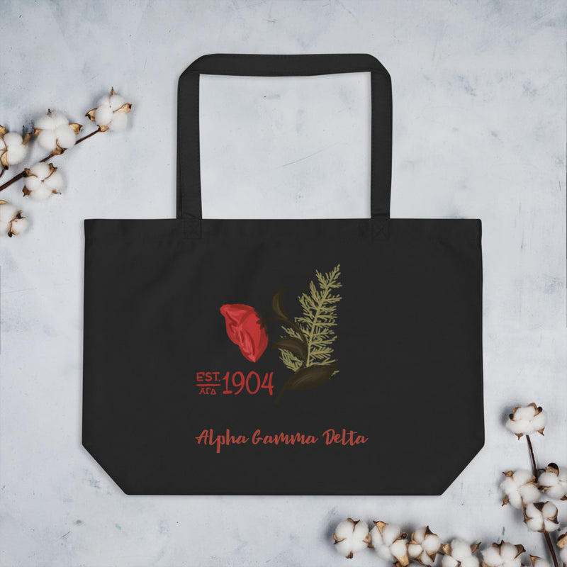 Alpha Gamma Delta 1904 Founders Day Large Organic Tote Bag in black shown flat with cotton blossoms