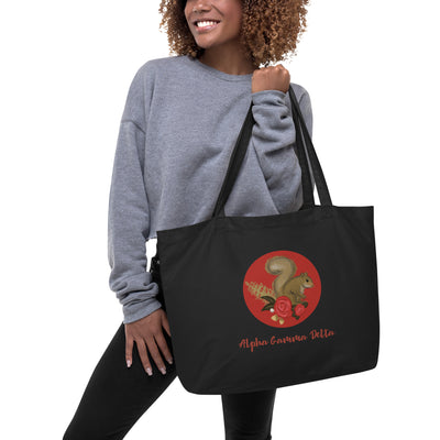 Alpha Gamma Delta Squirrel Large Organic Tote Bag shown in black on model's arm