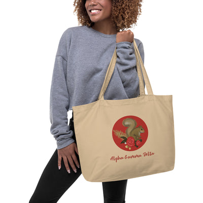 Alpha Gamma Delta Squirrel Large Organic Tote Bag in natural oyster on model's arm