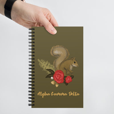 Alpha Gamma Delta Squirrel Spiral Notebook shown in model's hand