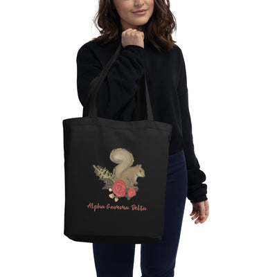 Alpha Gamma Delta Squirrel Eco Tote Bag shown in black on model's arm