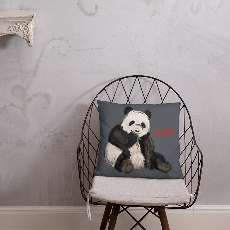 Alpha Omicron Pi Panda Pillow shown on chair