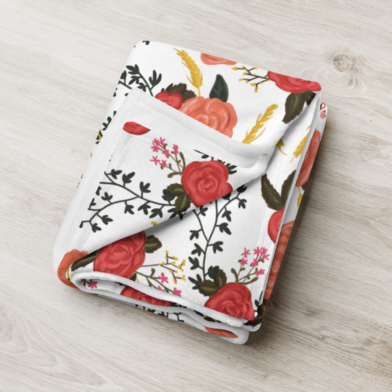 Folded Alpha Omicron Pi throw blanket with Greek Happy rose floral print. 