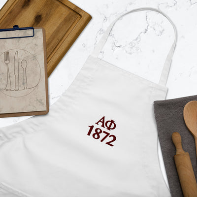 Alpha Phi 1872 Founding Year Embroidered Apron in white in kitchen scene