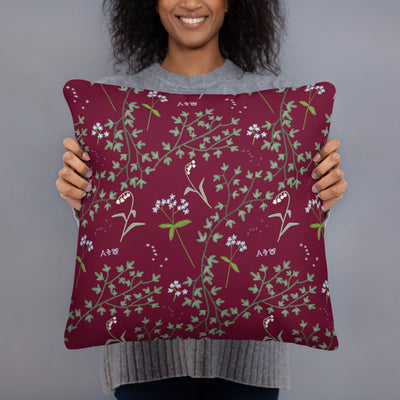 Reverse side of Alpha Phi 1872 Reversible Pillow showing floral print in model's hands