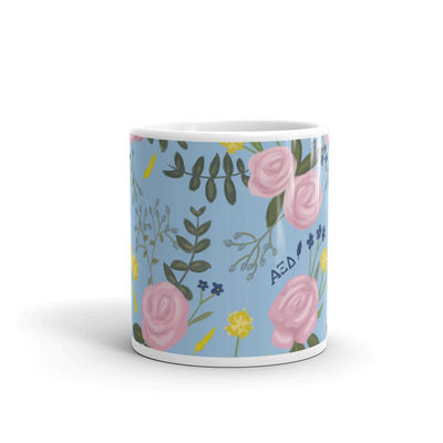 Alpha Xi Delta Sorority Mug in 11 oz size showing floral print wrapping around mug