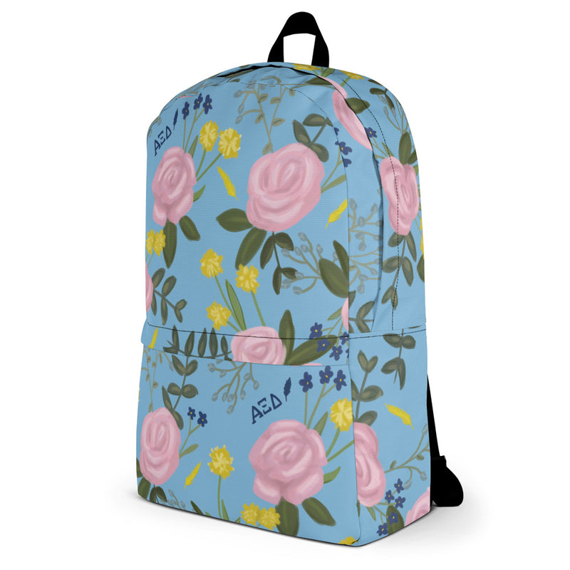 Alpha Xi Delta pink rose floral print backpack blue background showing side view