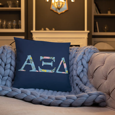 Alpha Xi Delta Greek Letters Navy Blue Pillow shown on couch