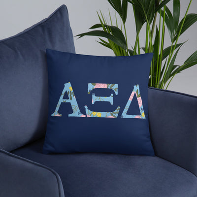 Alpha Xi Delta Greek Letters Navy Blue Pillow shown on blue chair